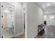 Hallway with wood floors, showing a bathroom and a glimpse of a bedroom at 5157 Citrus Leaf Blvd, Winter Garden, FL 34787