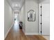 Bright hallway with wood floors, console table, and access to other rooms at 5157 Citrus Leaf Blvd, Winter Garden, FL 34787