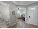 Light hallway with wood floors, featuring a powder room and home office at 5157 Citrus Leaf Blvd, Winter Garden, FL 34787