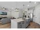 Modern kitchen with white cabinets and a large island at 5157 Citrus Leaf Blvd, Winter Garden, FL 34787