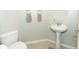 Small bathroom with pedestal sink, toilet, and neutral color palette at 528 Legacy Park Dr, Casselberry, FL 32707