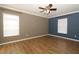 Bedroom with dark and light walls, wood floors, and ceiling fan at 528 Legacy Park Dr, Casselberry, FL 32707