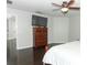 Bedroom with large TV, dresser, and dark floors at 528 Legacy Park Dr, Casselberry, FL 32707