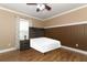 Guest bedroom with wood-look floors and window coverings at 528 Legacy Park Dr, Casselberry, FL 32707