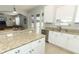 Kitchen with granite countertops, white cabinets, and a view of the backyard at 528 Legacy Park Dr, Casselberry, FL 32707