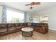 Spacious living room featuring a large brown sectional sofa and a wood coffee table at 528 Legacy Park Dr, Casselberry, FL 32707