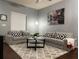 Comfortable living room featuring gray sofas, a coffee table, and stylish decor at 5352 Diplomat Ct # 103, Kissimmee, FL 34746