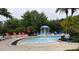 Community pool with mushroom fountain and plenty of lounge chairs at 5352 Diplomat Ct # 103, Kissimmee, FL 34746