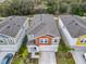 Aerial view of three townhouses, one with orange accents at 5381 Maddie Dr, Haines City, FL 33844