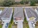 Aerial view of three townhouses, one with orange accents at 5381 Maddie Dr, Haines City, FL 33844