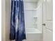 Clean bathroom with a tub shower and a galaxy print shower curtain at 5381 Maddie Dr, Haines City, FL 33844