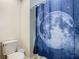 Bathroom with toilet and moon shower curtain at 5381 Maddie Dr, Haines City, FL 33844