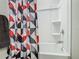 Clean bathroom with shower/tub combo, patterned shower curtain, and double sinks at 5381 Maddie Dr, Haines City, FL 33844