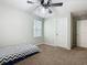 Bright bedroom with gray carpet and ceiling fan at 5381 Maddie Dr, Haines City, FL 33844