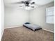 Cozy bedroom with gray carpet and ceiling fan at 5381 Maddie Dr, Haines City, FL 33844