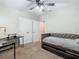 Spacious bedroom with daybed, desk, and ceiling fan at 5381 Maddie Dr, Haines City, FL 33844