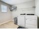 Bright laundry room, washer, dryer, and storage at 5381 Maddie Dr, Haines City, FL 33844