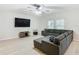 Open living room with L-shaped sectional sofa and wood-look floors at 5381 Maddie Dr, Haines City, FL 33844