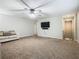 Living room with mounted TV, ceiling fan, and carpeted floor at 5381 Maddie Dr, Haines City, FL 33844