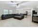 Open living room with L-shaped sectional sofa and wood-look floors at 5381 Maddie Dr, Haines City, FL 33844