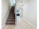 Modern staircase with brown carpet and light wood flooring at 5381 Maddie Dr, Haines City, FL 33844