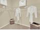 Walk-in closet with hanging rods and storage bins at 5863 Galloping Dr, Apopka, FL 32712