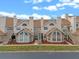 Tan two-story townhouses with brown roofs, stairs, and landscaping at 605 Youngstown Pkwy # 32, Altamonte Springs, FL 32714