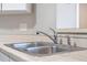 Double stainless steel sink with chrome faucet and tile backsplash at 605 Youngstown Pkwy # 32, Altamonte Springs, FL 32714