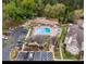 Aerial view of pool, spa, lounge chairs, palm trees, buildings, and parking spaces at 605 Youngstown Pkwy # 32, Altamonte Springs, FL 32714