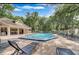Community pool with lounge chairs and covered patio, surrounded by lush landscaping at 605 Youngstown Pkwy # 32, Altamonte Springs, FL 32714