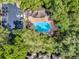 A bird's-eye view showing lush trees surrounding community pool, spa, and reserved parking spaces at 605 Youngstown Pkwy # 32, Altamonte Springs, FL 32714