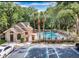Exterior view of the community pool surrounded by palm trees, lush greenery, and lounge chairs at 605 Youngstown Pkwy # 32, Altamonte Springs, FL 32714