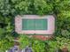 Aerial view of the tennis court, surrounded by trees and lush greenery at 605 Youngstown Pkwy # 32, Altamonte Springs, FL 32714