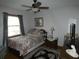 Cozy bedroom with a queen-size bed and wood flooring at 749 E Yorkshire Dr, Deland, FL 32724