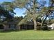 Brick ranch house with mature landscaping and a spacious yard at 749 E Yorkshire Dr, Deland, FL 32724