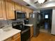 Kitchen with stainless steel appliances and wood cabinets at 749 E Yorkshire Dr, Deland, FL 32724