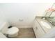 Small powder room with single sink vanity and gray tile floor at 8545 Couples St, Davenport, FL 33896