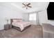 Main bedroom with ceiling fan, large window and plush carpeting at 8545 Couples St, Davenport, FL 33896