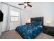 Guest bedroom with ceiling fan and window coverings at 8545 Couples St, Davenport, FL 33896