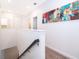 Upstairs hallway with carpet and a large piece of artwork at 8545 Couples St, Davenport, FL 33896