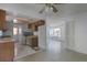 Basic kitchen with wood cabinets and a view of the living area at 881 Kimball Dr, Ocoee, FL 34761