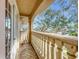 Private balcony with stone balustrade and treetop views at 910 Lotus Vista Dr # 201, Altamonte Springs, FL 32714