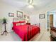 Guest bedroom with red bedding and double door closet at 910 Lotus Vista Dr # 201, Altamonte Springs, FL 32714