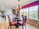 Elegant dining room with glass table and richly colored chairs, offering a view at 910 Lotus Vista Dr # 201, Altamonte Springs, FL 32714