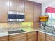 Modern kitchen with granite countertops and microwave at 910 Lotus Vista Dr # 201, Altamonte Springs, FL 32714