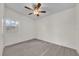 Bright bedroom with ceiling fan and grey wood flooring at 923 Ferndell Rd, Orlando, FL 32808