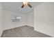 Bright bedroom with ceiling fan and grey vinyl plank flooring at 923 Ferndell Rd, Orlando, FL 32808