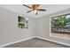 Bedroom with ceiling fan and large window offering backyard views at 923 Ferndell Rd, Orlando, FL 32808