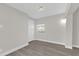 Bright bedroom featuring wood-look floors and neutral walls at 923 Ferndell Rd, Orlando, FL 32808