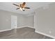 Well-lit bedroom, ceiling fan, and wood-look floors at 923 Ferndell Rd, Orlando, FL 32808